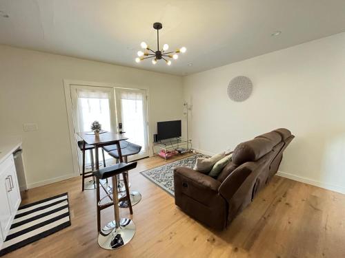 a living room with a couch and a table at Modern Studio in MarysVille A Forest Haven in Marysville