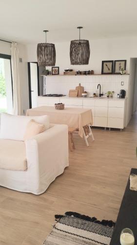 a living room with a white couch and a table at Casita REFUGIO in Suipacha