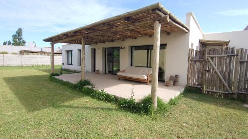 a pavilion with a bed in a yard at Casita REFUGIO in Suipacha