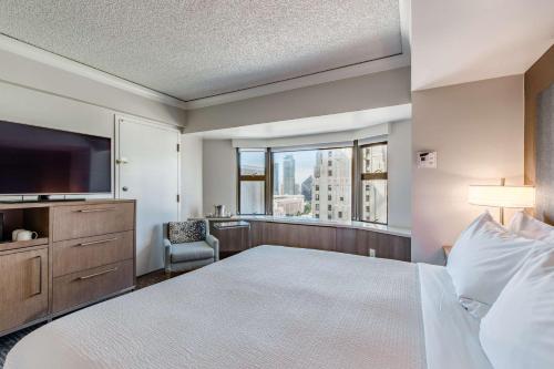 a hotel room with a bed and a large window at Coast Seattle Downtown Hotel by APA in Seattle