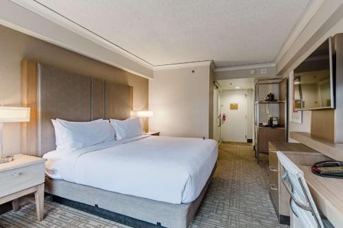 a hotel room with a large bed and a kitchen at Coast Seattle Downtown Hotel by APA in Seattle