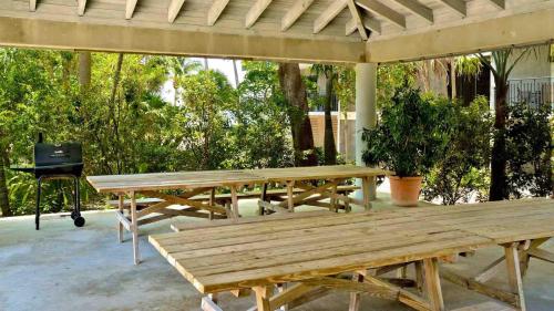 a group of picnic tables on a patio at Conch in the Treetops by Last Key Realty in Key West