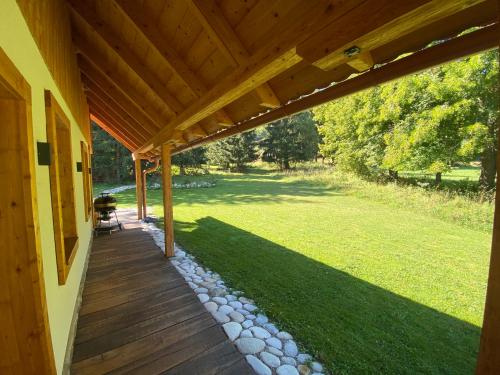 a porch of a house with a wooden roof at Chata Šuhaj in Liptovský Mikuláš