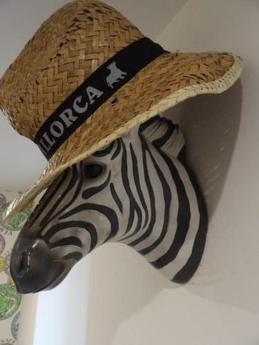 a hat on top of a zebra head on a wall at Modern 3BHK near Edinburgh zoo in Edinburgh