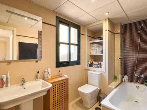 a bathroom with a sink and a toilet and a tub at Las Flores 3 in Fuengirola