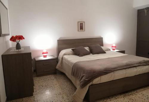 a bedroom with a large bed with two night stands at La villetta di Capolaia in Introdacqua