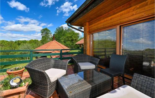 a screened porch with chairs and a gazebo at Cozy Home In Ribnjacka With Kitchen in Ribnjačka