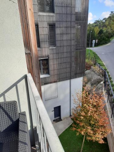 a balcony of a building with a chair and a window at Pod hrází & Sedmé nebe in Staré Splavy