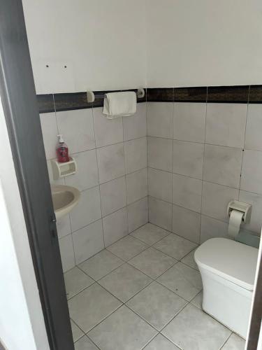 a bathroom with a toilet and a sink at Bello Departamento en el Prado in Cochabamba