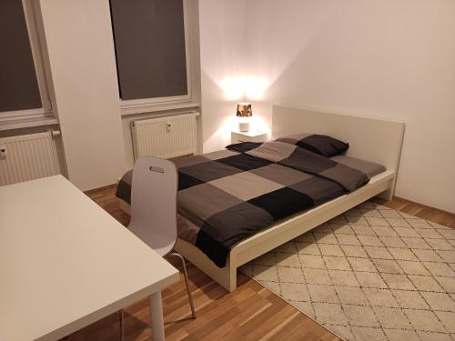 a bedroom with a bed and a table with a lamp at Komfortable Wohnung in Kassel