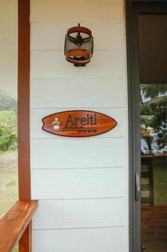 a surfboard hanging on the side of a door at Teahupo'o Wave Lodge in Teahupoo