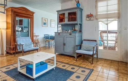a kitchen with blue chairs and a table in a room at Beautiful Home In St-Georges-De-Didonne in Saint-Georges-de-Didonne