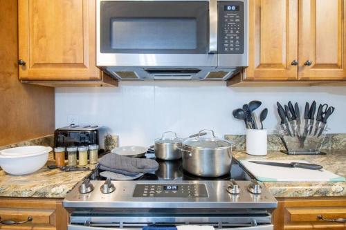a kitchen with a stove with pots and pans at Family Home and Studio by Brick and Home in Taylors