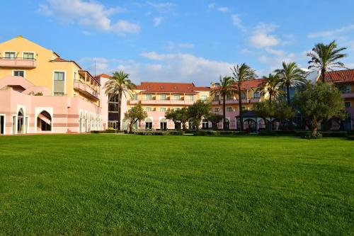 a large grassy field in front of a building at Pestana Sintra Golf Resort & SPA Hotel in Sintra