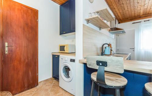 a kitchen with a sink and a washing machine at 3 Bedroom Awesome Apartment In Klek in Klek
