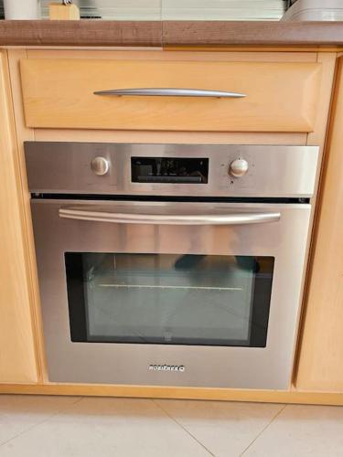 un four en acier inoxydable dans un meuble de cuisine dans l'établissement Renewed Spacious 35m2 Studio in Paris, à Paris