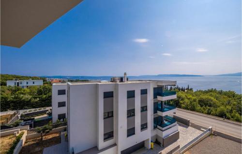 an apartment building with a view of the water at Nice Apartment In Kostrena With Wifi in Kostrena
