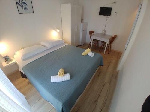 a bedroom with a bed with two towels on it at Apartment Svetka in Sali