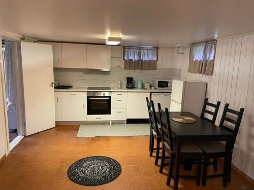 a kitchen with a table and chairs in a room at Independent Apartment in Sandnes in Sandnes