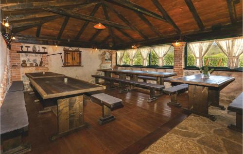 a large room with wooden tables and benches at Three-Bedroom Holiday Home In Dugogabe in Dugobabe
