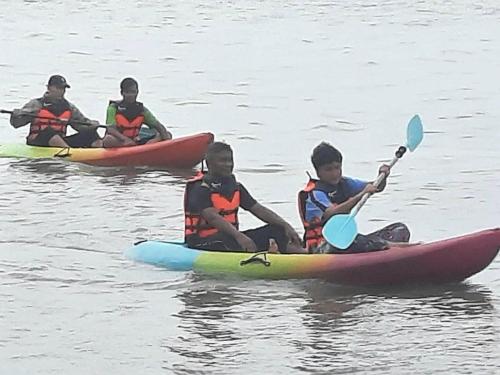a group of children sitting on kayaks in the water at The White House Pakbara in Ban Pak Ba Ra