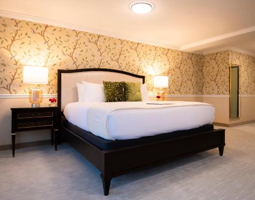 a bedroom with a large bed and two lamps at The Pathmaker Hotel in Bar Harbor