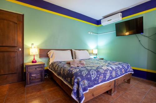 a bedroom with a bed and a night stand with a lamp at Casa Juarez B&B in La Paz