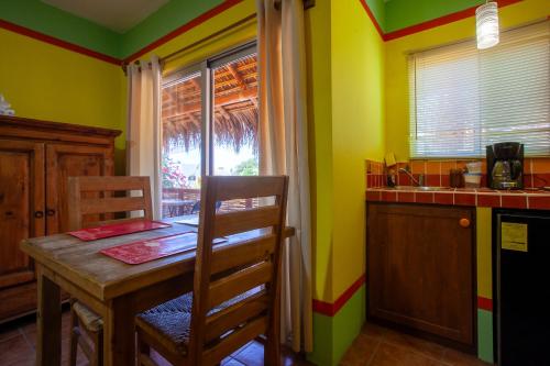 a small kitchen with a table and a window at Casa Juarez B&B in La Paz