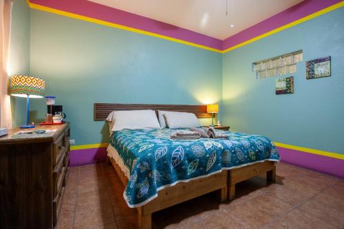 a bedroom with a bed and a dresser in it at Casa Juarez B&B in La Paz