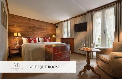 a hotel room with a bed and a chair at Monte Rosa Boutique Hotel in Zermatt