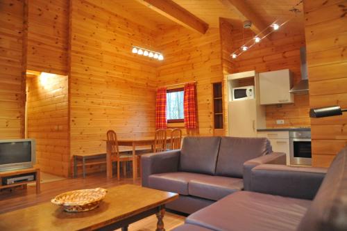 a living room with a couch and a table at Gite De Boshut in Oignies-en-Thierache