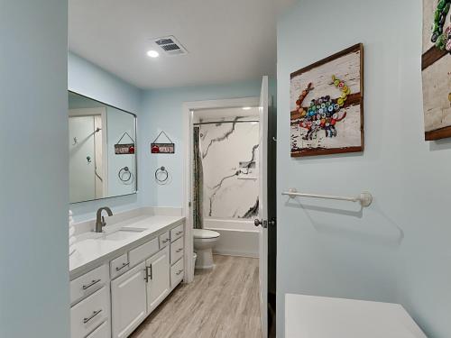 a bathroom with a sink and a toilet and a shower at The Enclave #705 in Orange Beach