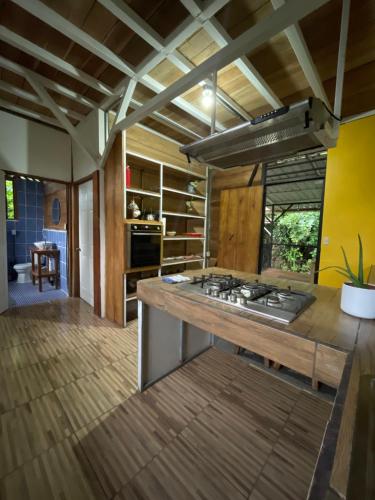 a kitchen with a wooden island with a stove at Vimanas Surf Loft in Talamanca