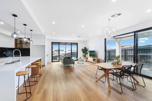 a kitchen and living room with a table and chairs at Highton Haven Spacious & Serene in Highton