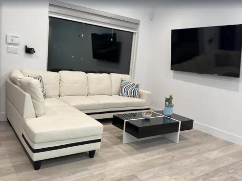 a living room with a white couch and a coffee table at Dimond Abode Vacation Rental, Oakland California Dimond District in Oakland