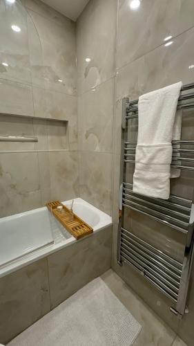 a bathroom with a shower with a sink and a tub at Double room with garden view in London