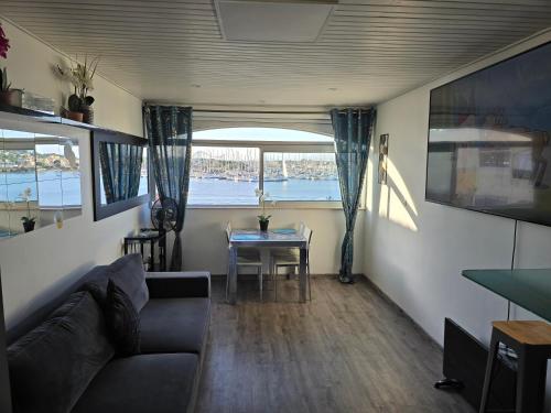 a living room with a couch and a table at 46 Île Paradise Vue Port in Cap d'Agde