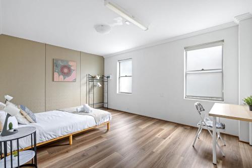 a bedroom with a bed and a table and chairs at Detached Double Room in Revesby - Tranquil Place - Shared Bathroom in Revesby