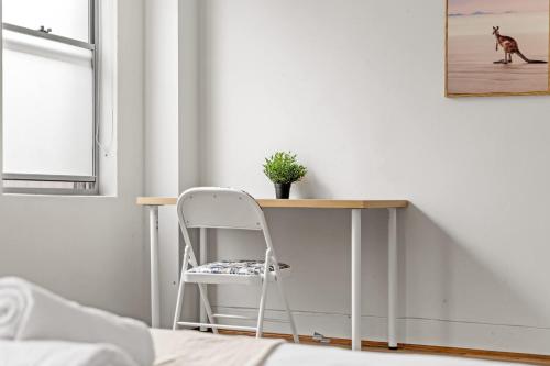 a chair sitting next to a desk in a room at Detached Double Room in Revesby - Tranquil Place - Shared Bathroom in Revesby