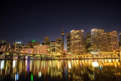 a view of a city at night with a river at Modern Queen Room - Private Spot at Revesby - Shared Bathroom in Revesby