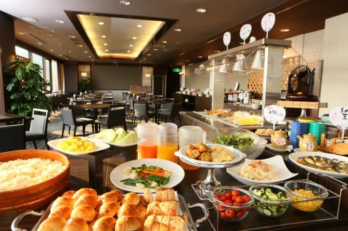 a buffet of food on a table in a restaurant at Hotel Anesis Seto-Ohashi in Utazu
