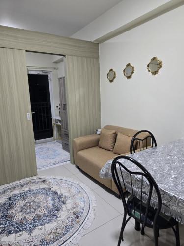 a living room with a couch and a table at Rhoydez Condotel Breeze Residence in Manila