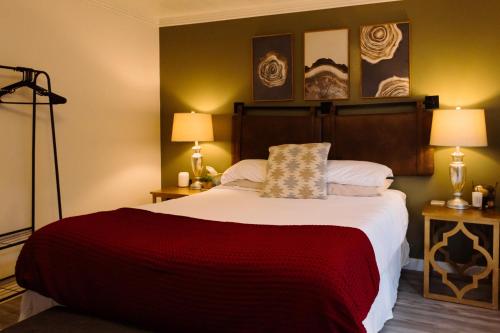 a bedroom with a large bed and two lamps at It's The Little Things in Virgin