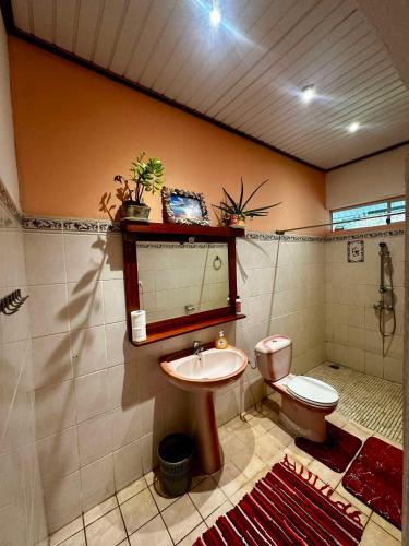 a bathroom with a toilet and a sink at Pension Villa TEKO in Nuku Hiva