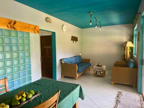 a living room with a table and a couch at Pension Villa TEKO in Nuku Hiva