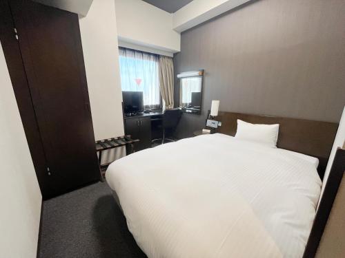 Ένα ή περισσότερα κρεβάτια σε δωμάτιο στο Hotel Route-Inn Fukui Ekimae