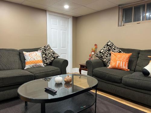 a living room with two couches and a coffee table at The Rustic Barn in Brampton