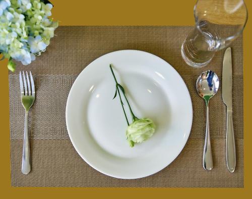 a white plate with a piece of food on a table at Tropical Paradise Sapa Hotel & Tour in Sa Pa