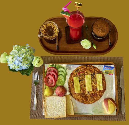 a tray of food with a pizza and a drink at Tropical Paradise Sapa Hotel & Tour in Sa Pa