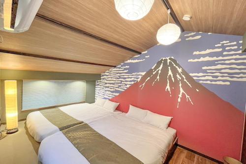 a bedroom with a mountain mural on the wall at Traditional Japanese House, 100years, Renovated into Japanese art, Shinsekai in Osaka